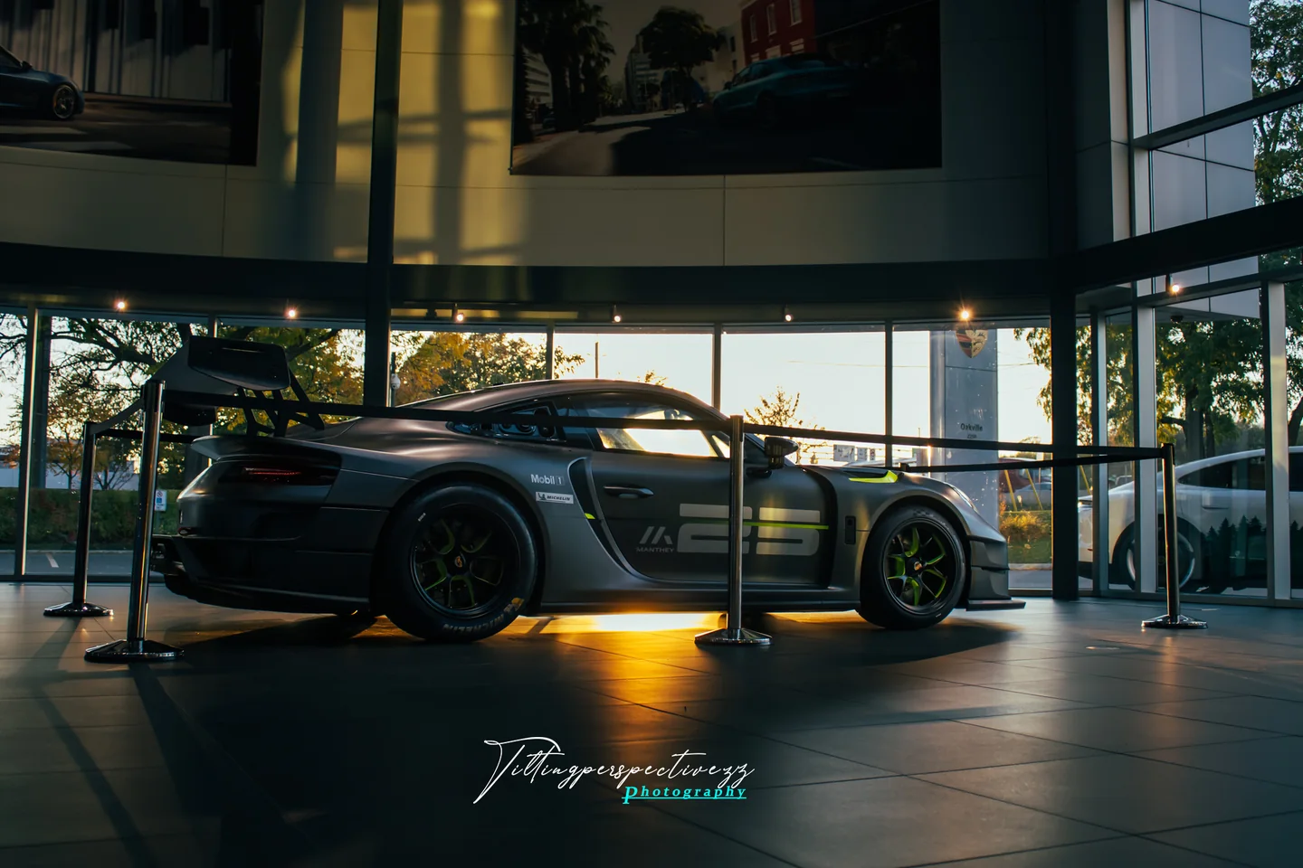 A Porsche GT2 RS Clubsport roped off on a polished showroom floor.